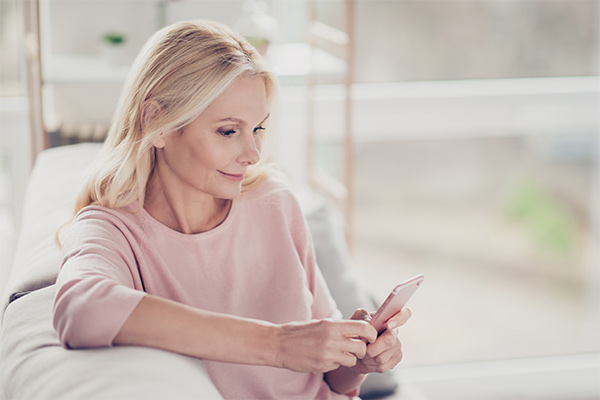 Elder woman looking at smartphone