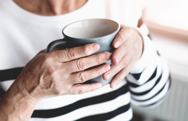 Elder woman holding cup