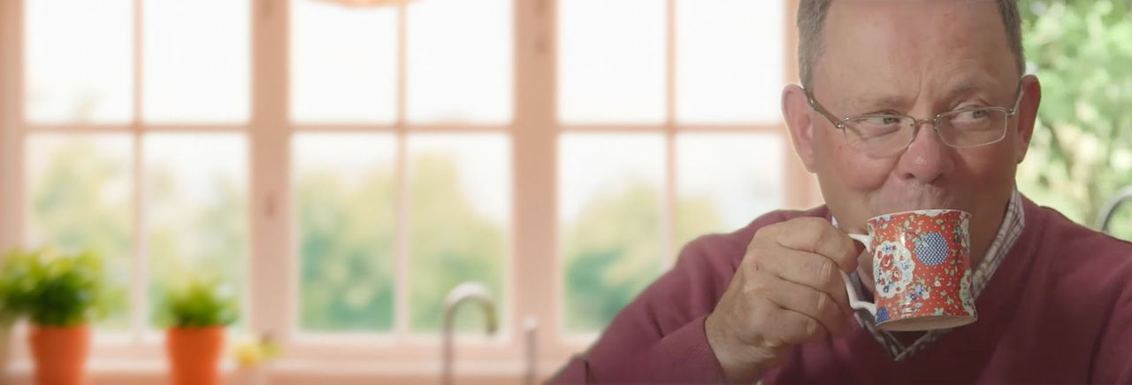 Elderly gentleman drinks a cup of coffee without any problems thanks to DBS